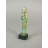 An Egyptian faience ushabti of the Priest Horudja, Late Dynastic period,