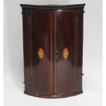 A Regency mahogany boxwood line strung bowfronted wall hanging corner cabinet,