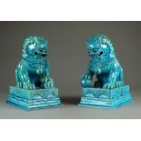 A pair of Chinese turquoise glazed guardian lions, Republic period, modelled seated on plinth bases,