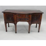 An early 19th century mahogany satinwood banded serpentine sideboard, of small proportions,