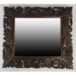 A Victorian oak framed wall mirror, carved with acanthus leaves by Edwin Ridgeway, 93cm wide,