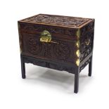 A Chinese brass bound rosewood trunk on stand, late Qing Dynasty, of rectangular outline,