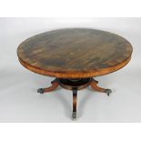 A Regency rosewood brass inlaid pedestal centre / dining table,