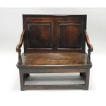 A joined oak two panel settle, elements 18th century,