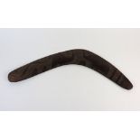 An Australian carved hard wood boomerang the decoration to one side only depicting two emus and a