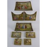 A group of eight 19th century Viennese enamel plaques in gilt metal surrounds each showing