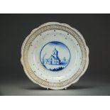 A Caughley dessert plate with a blue painted scene within a gilt spangled border, circa 1785-93,