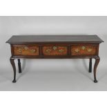 A George III oak crossbanded mahogany three drawer dresser base the two plank top over three short
