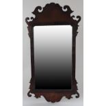 An 18th century and later walnut scroll-cut mirror, 49.
