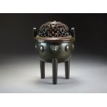 A Chinese bronze tripod censer with silver wire inlay, Qing Dynasty, in the form of a ding,