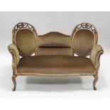 An Edwardian mahogany serpentine sofa, in the Adam style with oval padded swag moulded back,