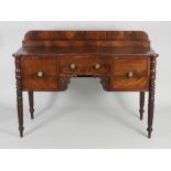 A William IV mahogany sideboard the low shelf back over a concave central short drawer flanked by a