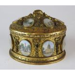 A late 19th / early 20th century Grand Tour style gilt metal oval jewellery casket, with hinged lid,