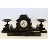 A late 19th century Aesthetic black slate and rouge marble clock garniture,