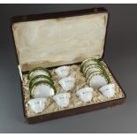 A cased Royal Worcester tea service comprising six cups and six saucers decorated with a single