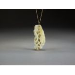 A Chinese pale green russet veined jade pendant, Qing Dynasty,