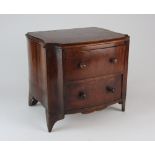 A George III mahogany Hepplewhite style miniature chest of two drawers fitted with turned wooden