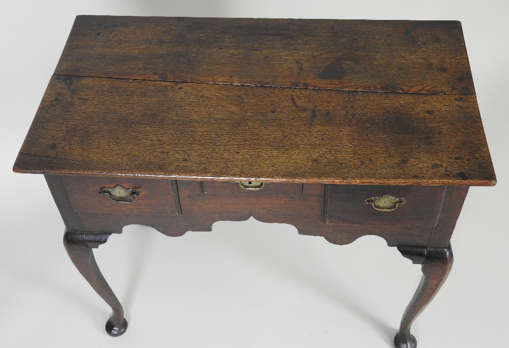 A mid 18th century oak lowboy the rectangular plank top over an arrangement of three short drawers - Image 2 of 2
