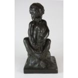 A dark brown patinated bronze figure of a child playing the pipes cast after a model by Amedeo