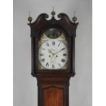 An early 19th century oak eight day longcase clock, the 14 inch arch enamel dial signed W Devey,