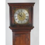 An 18th century oak eight day longcase clock, the 12 inch square brass dial signed Tho Baker,