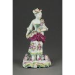 An early Derby porcelain figure of a girl draped with flowers, circa 1755/60, paper label for H.R.