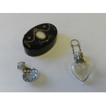 A white metal topped heart shaped glass perfume bottle together with a pique work tortoiseshell