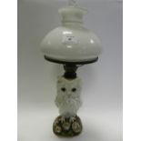 A Victorian porcelain owl table lamp with milk glass shade,