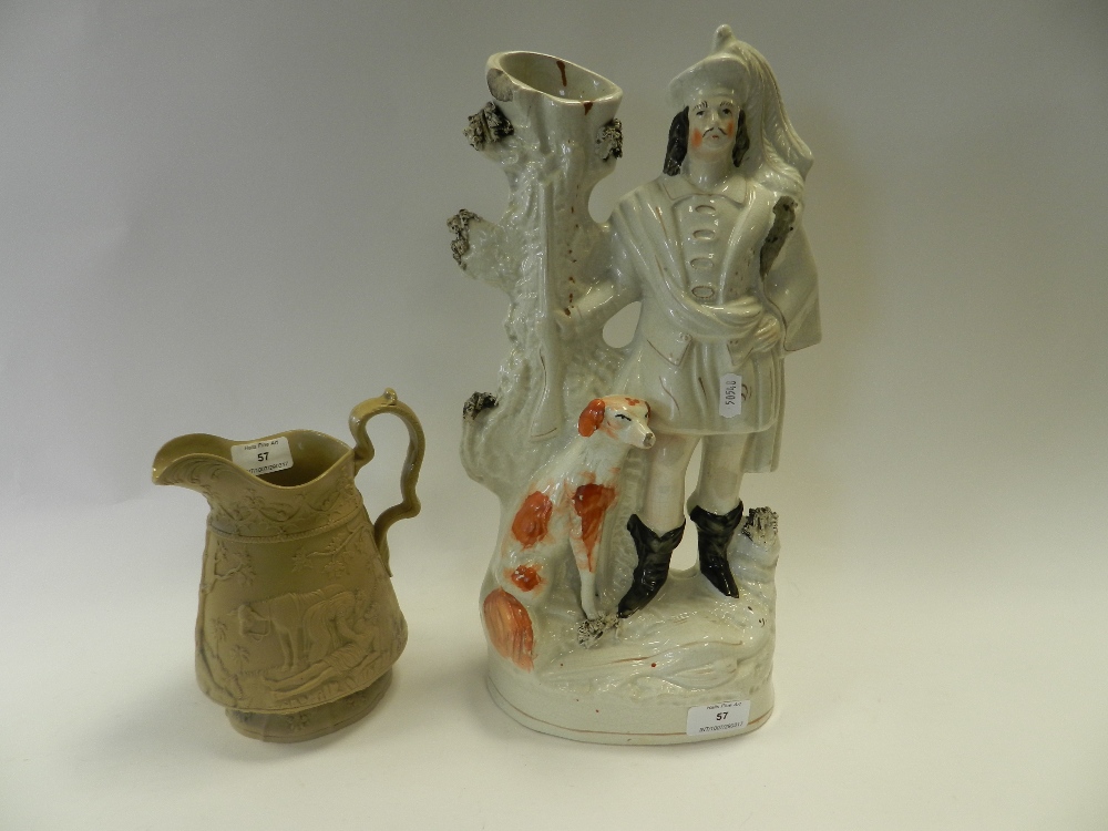 A Staffordshire figure of a highland huntsman together with a Jones & Waldey buff stoneware relief