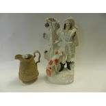 A Staffordshire figure of a highland huntsman together with a Jones & Waldey buff stoneware relief