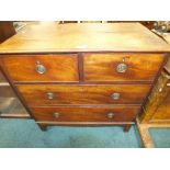 A George III mahogany chest of two short over two long drawers fitted with brass ring handles