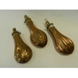 Three 19th Century embossed copper and brass powder flasks