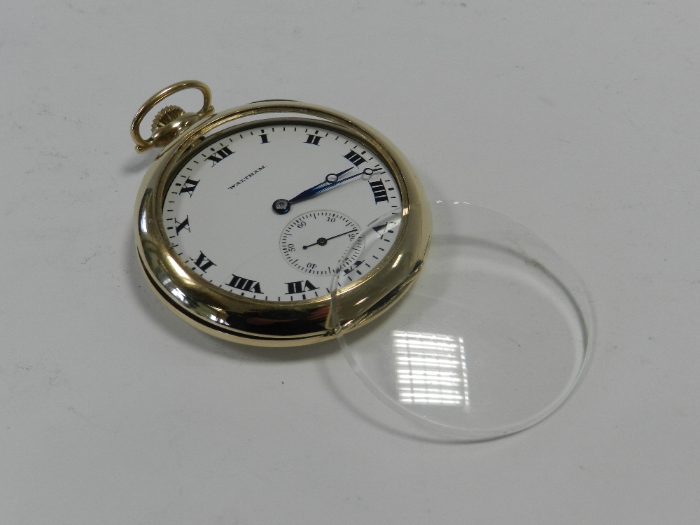 A yellow metal Waltham open face pocket watch,