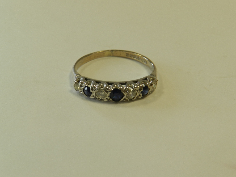 An 18ct white gold seven stone sapphire and diamond ring