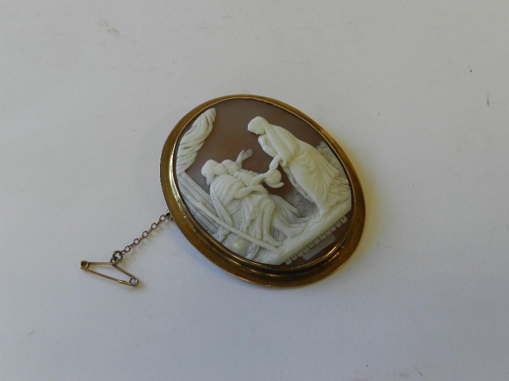 An oval shell cameo brooch within yellow metal mount stamped 9ct