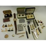 A large collection of loose coinage together with a pipe holder and pipes, a wristwatch,