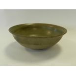 A Chinese celadon bowl internally glazed, partly glazed exterior Ming period,