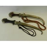 Two Middle Eastern jambiya style daggers in metal scabbards