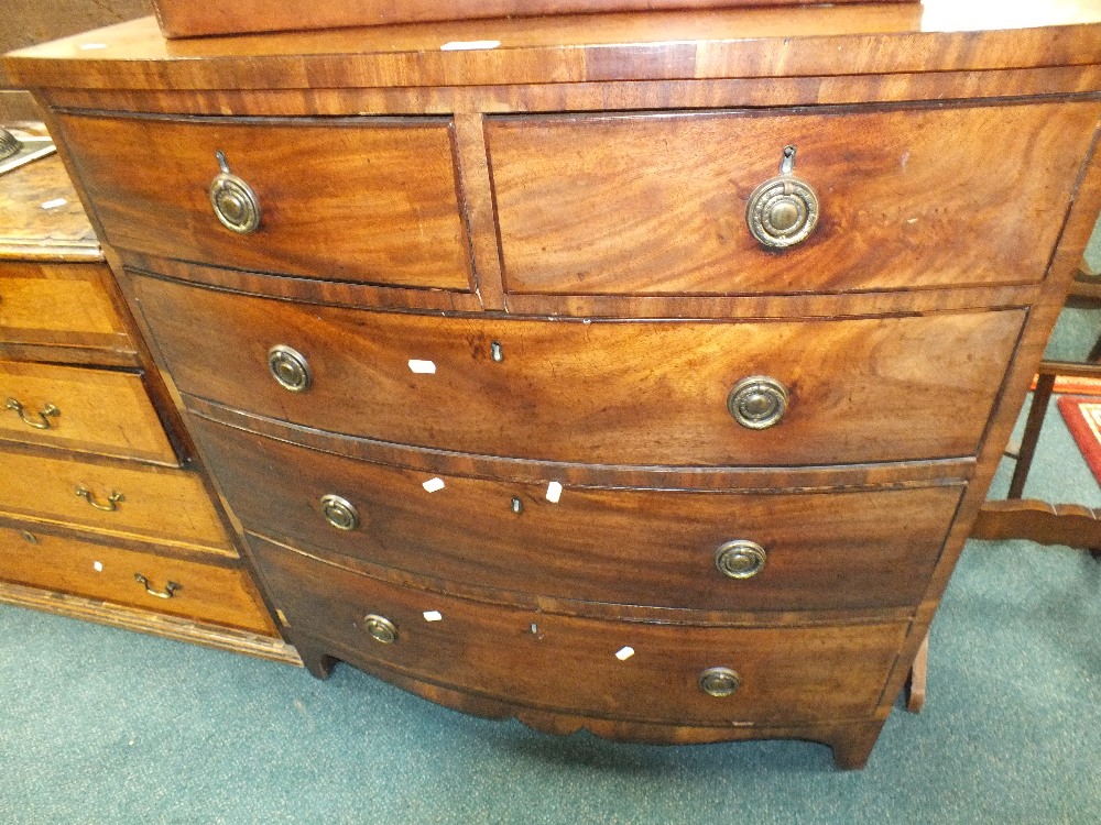 A 19th century mahogany bowfront chest of two short over three long drawers fitted with brass ring