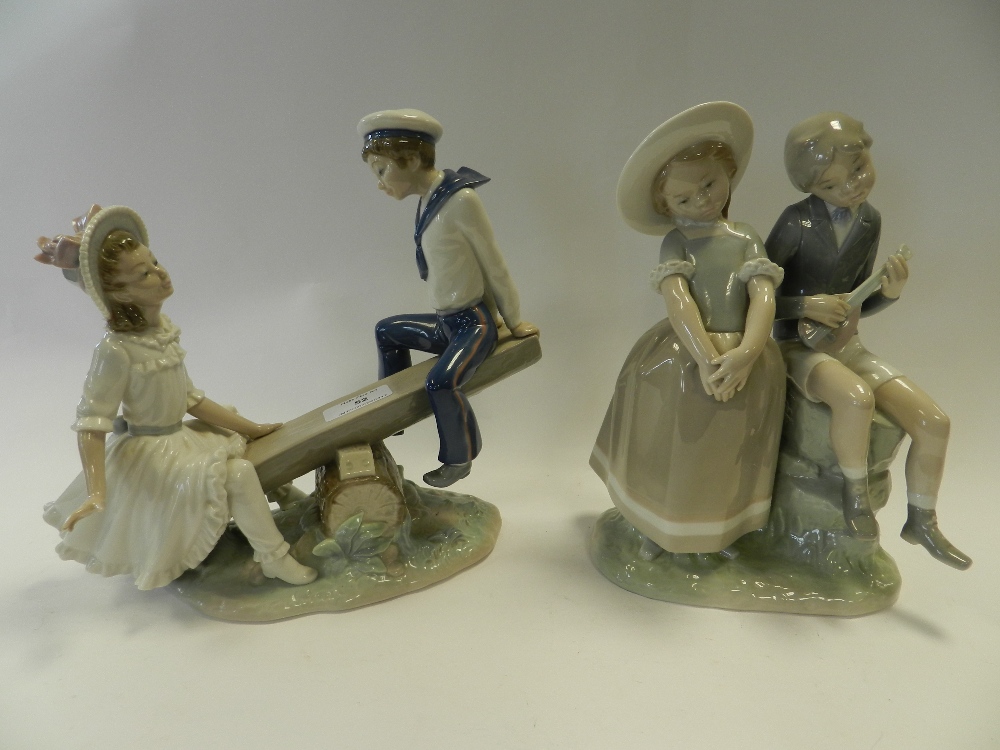 A Lladro group of children on a log seesaw and another Lladro group of two children the boy sitting