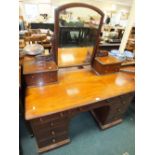 A Victorian mahogany kneehole dressing table by Gillows Lancaster with swivel central mirror,