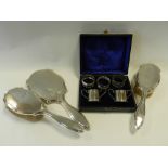 Two silver salts together with two silver napkin rings,