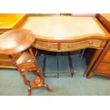 A modern serpentine desk with two frieze drawers along with a modern serpentine three tier wall