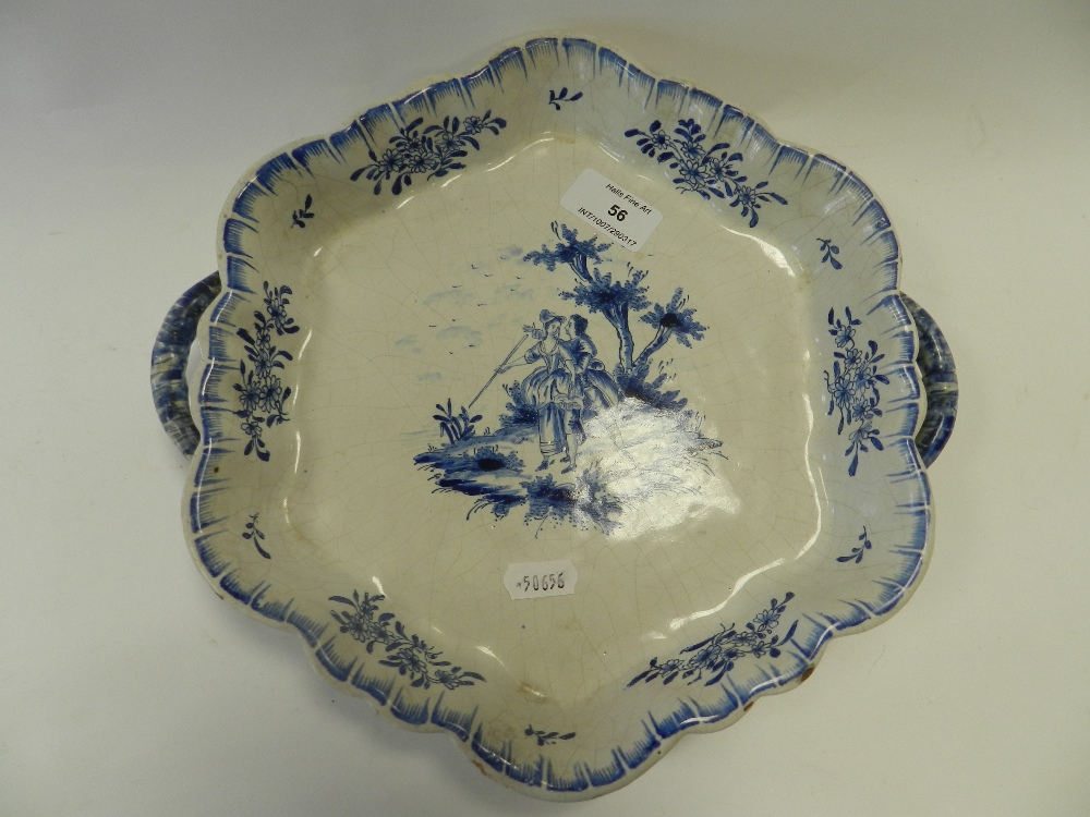 A Dutch Delft crimped hexagonal two handled tray decorated with a blue and white tray decorated