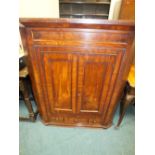 A 19th century mahogany straight fronted cabinet the two cabinet doors over false short drawer