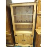 A modern pine floor standing open cabinet with enclosed base