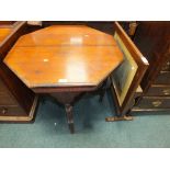 An Edwardian walnut octagonal centre table and an early 20th century metamorphic fire