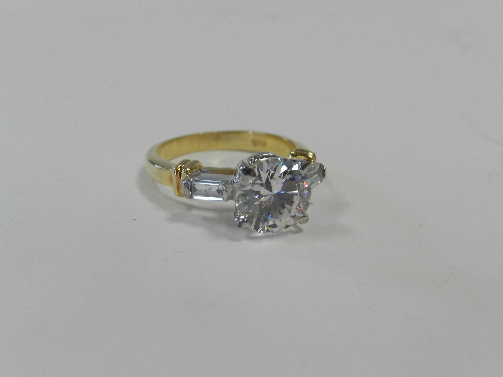 A diamond simulant dress ring with yellow metal shank stamped 18