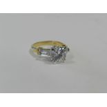 A diamond simulant dress ring with yellow metal shank stamped 18