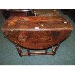 An 18th century and later oak gate-leg breakfast table with reduced oval top and end frieze drawer